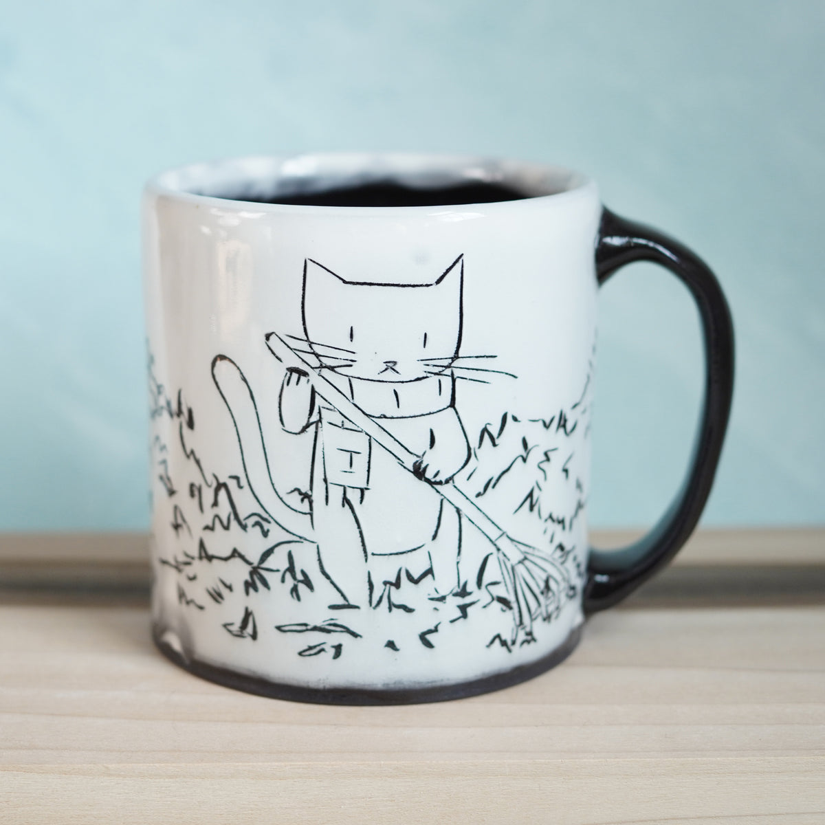 Black & White Cats Raking Leaves Mug