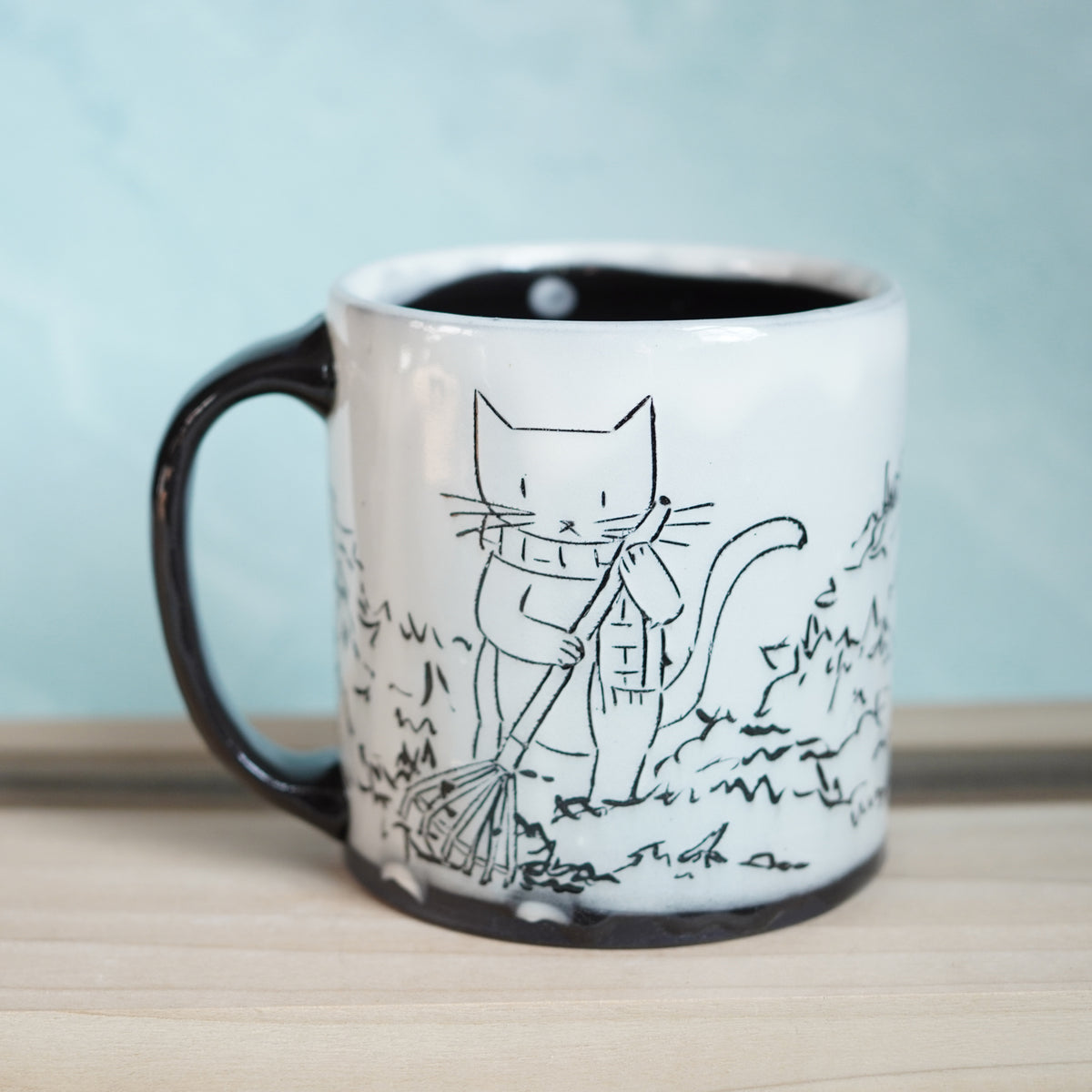 Black & White Cats Raking Leaves Mug